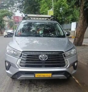 Toyota Innova outstation taxi parked on roadside for cheapest outstation cabs in Bangalore by Arunodaya Cabs